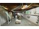 Unfinished basement with exposed pipes and some furniture at 224 Sourwood Dr, Marietta, GA 30062