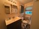 Bathroom featuring a sink, mirror, toilet and patterned floor at 224 Sourwood Dr, Marietta, GA 30062