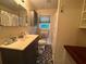 Bathroom featuring a sink, mirror, toilet and patterned floor at 224 Sourwood Dr, Marietta, GA 30062