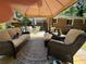 View of cozy covered outdoor deck featuring comfortable wicker seating and decorative outdoor rug, perfect for relaxation at 224 Sourwood Dr, Marietta, GA 30062