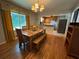 Open dining room with hardwood floors and view into adjacent kitchen at 224 Sourwood Dr, Marietta, GA 30062