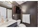 Bathroom featuring a single sink vanity, dark walls, and a bath tub at 3150 Stonewyck Pl, Decatur, GA 30033