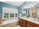 Bathroom featuring a soaking tub, double vanity, and ample natural light at 3150 Stonewyck Pl, Decatur, GA 30033
