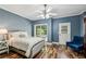 Cozy bedroom with ceiling fan, hardwood floors and a comfortable seating area at 3150 Stonewyck Pl, Decatur, GA 30033