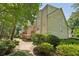 View of the townhouse exteriors showing the balconies and surrounding green space at 3150 Stonewyck Pl, Decatur, GA 30033