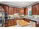 Modern kitchen featuring stainless steel appliances, wooden cabinets, and ample counter space at 3150 Stonewyck Pl, Decatur, GA 30033