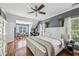 Bright main bedroom featuring a large bed, hardwood floors and neutral colors at 3150 Stonewyck Pl, Decatur, GA 30033