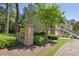 Community signage surrounded by lush landscaping and nearby townhome exteriors at 3150 Stonewyck Pl, Decatur, GA 30033
