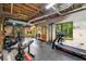 Spacious basement gym featuring exposed ceiling, fitness equipment, and natural light from large windows at 4710 Misty Lake Ne Ct, Kennesaw, GA 30144