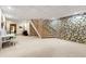 Finished basement with carpet and decorative stone wall at 4710 Misty Lake Ne Ct, Kennesaw, GA 30144