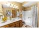 Bright bathroom featuring wood vanity, decorative mirror and modern shower-tub combo at 4710 Misty Lake Ne Ct, Kennesaw, GA 30144