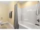 Bright bathroom with a shower-tub combo and tile floors at 4710 Misty Lake Ne Ct, Kennesaw, GA 30144