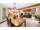 Spacious dining room featuring a wood table, modern chandelier, and a view to the living room at 4710 Misty Lake Ne Ct, Kennesaw, GA 30144