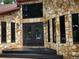 Close-up of the front door showcasing stone detail, transom window, and modern hardware at 4710 Misty Lake Ne Ct, Kennesaw, GA 30144
