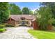 Charming single-story home with stone accents, mature trees, and a spacious driveway at 4710 Misty Lake Ne Ct, Kennesaw, GA 30144