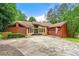 Charming single-story home with stone accents, mature trees, and a spacious driveway at 4710 Misty Lake Ne Ct, Kennesaw, GA 30144