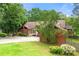 Charming single-story home with stone accents, mature trees, and a well-maintained lawn at 4710 Misty Lake Ne Ct, Kennesaw, GA 30144