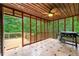 Enclosed porch with ceiling fan and a grill overlooking the wooded backyard at 4710 Misty Lake Ne Ct, Kennesaw, GA 30144