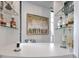 Stylish home bar area with glass shelves, liquor bottles, modern design, and chic artwork at 75 14Th St Ne # 4140, Atlanta, GA 30309