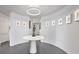 Circular hallway with a decorative table, modern lighting, artwork, and neutral color scheme at 75 14Th St Ne # 4140, Atlanta, GA 30309