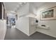 Sleek hallway featuring minimalist decor, track lighting, and a glimpse into a living area at 75 14Th St Ne # 4140, Atlanta, GA 30309