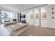Bright living room featuring stylish chaise lounges, modern art, and a large sliding glass door to outdoor balcony at 75 14Th St Ne # 4140, Atlanta, GA 30309