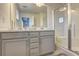 Modern bathroom with double vanity, gray cabinets, and a glass-enclosed shower at 1005 Belfry Ter, Fairburn, GA 30213