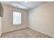 Simple bedroom with a window and neutral carpet, providing a blank canvas at 1005 Belfry Ter, Fairburn, GA 30213