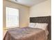 Well-lit bedroom with a large window, a comfy bed with a decorative headboard at 1005 Belfry Ter, Fairburn, GA 30213