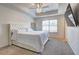Serene primary bedroom with a plush upholstered headboard and a modern ceiling fan at 1005 Belfry Ter, Fairburn, GA 30213