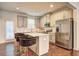 Well-appointed kitchen featuring a central island, stainless steel appliances, and stylish bar seating at 1005 Belfry Ter, Fairburn, GA 30213