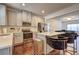 Modern kitchen with stainless steel appliances, a large island with barstools, and sleek cabinetry at 1005 Belfry Ter, Fairburn, GA 30213