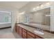 Bathroom featuring granite counters, double vanity, shower, bathtub and a view into the bedroom at 1211 Riverscall Ln, Atlanta, GA 30339