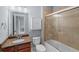 Bathroom featuring a tile shower over tub, granite countertop and modern fixtures at 1211 Riverscall Ln, Atlanta, GA 30339