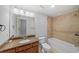Bathroom featuring a tile shower over tub, granite countertop and modern fixtures at 1211 Riverscall Ln, Atlanta, GA 30339