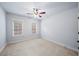 Bright bedroom featuring carpet, two windows with blinds, and neutral colored walls at 1211 Riverscall Ln, Atlanta, GA 30339