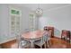 Elegant dining room featuring wood floors, neutral walls and a stylish light fixture at 1211 Riverscall Ln, Atlanta, GA 30339