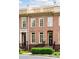 Charming brick townhome with a rooftop deck, front garden, and welcoming entrance at 1211 Riverscall Ln, Atlanta, GA 30339