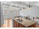 Bright living room with coffered ceilings, hardwood floors, and an open floor plan to the kitchen at 1211 Riverscall Ln, Atlanta, GA 30339