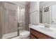 Modern bathroom featuring a glass-enclosed shower, a white vanity, and updated fixtures at 4815 Edgemoore Trce, Cumming, GA 30040