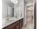 Bathroom featuring double sinks, neutral decor, and a doorway leading to the bedroom at 4815 Edgemoore Trce, Cumming, GA 30040