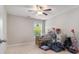 Neutral bedroom with ceiling fan and natural light peering through the window at 4815 Edgemoore Trce, Cumming, GA 30040