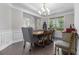 Dining room with hardwood floors, crown molding, large windows, and chandelier at 4815 Edgemoore Trce, Cumming, GA 30040