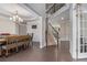 Formal dining room with modern chandelier, staircase, and beautiful hardwood floors at 4815 Edgemoore Trce, Cumming, GA 30040