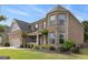 Charming two-story home featuring brick and stone exterior with lush landscaping in the front yard at 4815 Edgemoore Trce, Cumming, GA 30040