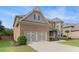 Charming brick home featuring a two-car garage, manicured lawn, and stylish architectural details at 4815 Edgemoore Trce, Cumming, GA 30040