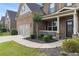 A well-maintained home with a two car garage, landscaped front yard and welcoming front porch at 4815 Edgemoore Trce, Cumming, GA 30040