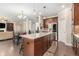 Open-concept kitchen with a large island, stainless steel appliances, and seamless access to the living area at 4815 Edgemoore Trce, Cumming, GA 30040