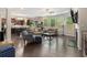 Open living room with dark wood floors, fireplace, and access to kitchen at 4815 Edgemoore Trce, Cumming, GA 30040