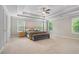 Spacious main bedroom boasts a tray ceiling, fan and lots of natural light at 4815 Edgemoore Trce, Cumming, GA 30040